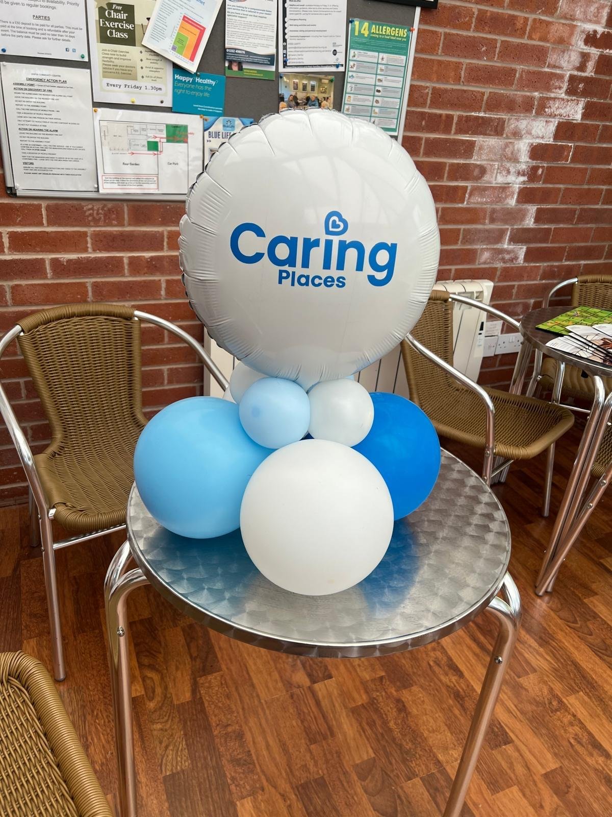 A Caring Places branded balloon centrepiece set up to welcome guests