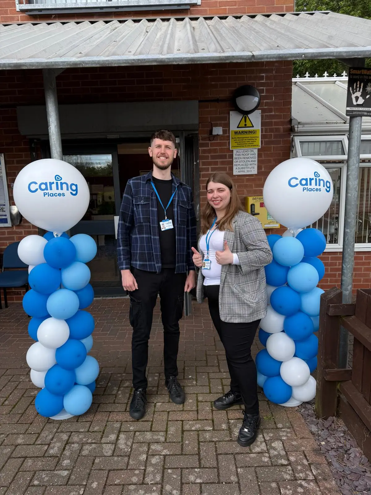 The Caring Places team welcoming guests at the entrance of Sinfin Community Centre on Open Day